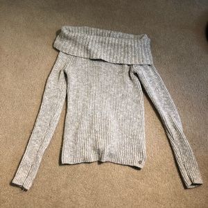 Off the shoulder sweater in a gray/ white color